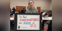 Teacher holding sign